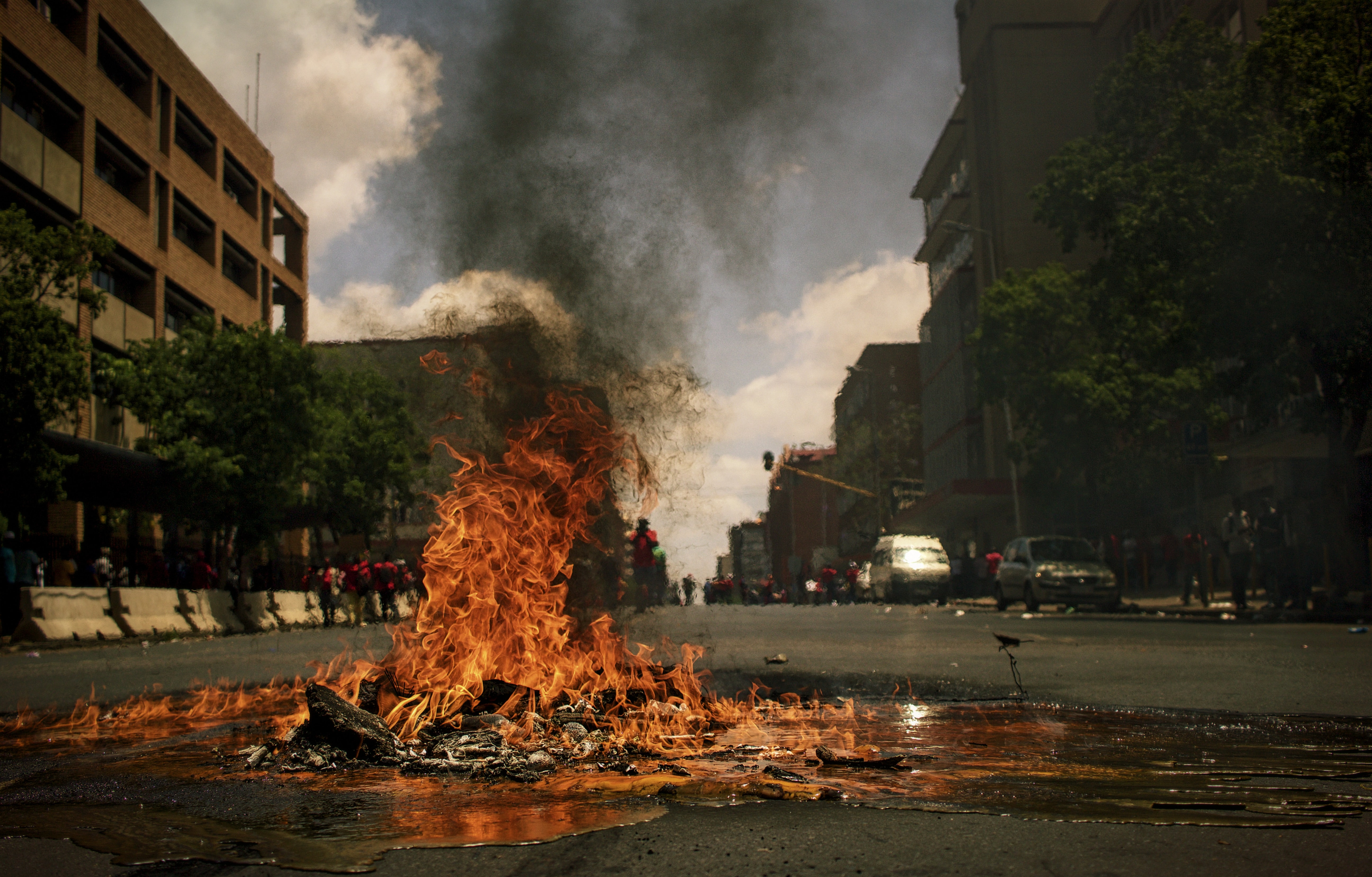 A photo by Pawel Janiak of something burning in the middle of a street.